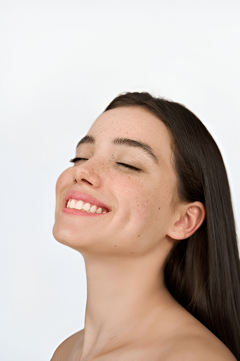 A young woman with radiant skin and bright teeth featured in Bright Dental’s Botox campaign.