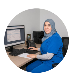 Fouzia, Clinical Director and internationally trained dentist, working at a clinic workstation during advanced clinical training